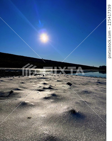 Frozen Shore Under Winter Sun Frozen Shore Under Winter Sun 125417339