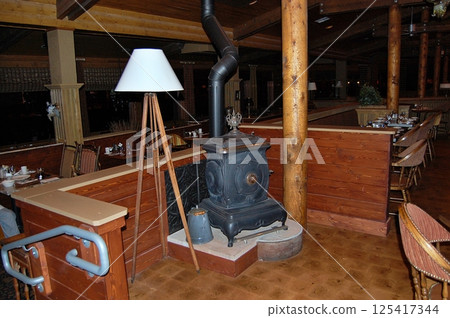 Rustic Lodge Interior with Vintage Wood Stove Rustic Lodge Interior with Vintage Wood Stove 125417344