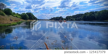 Serene River Landscape with Reflections 125417379