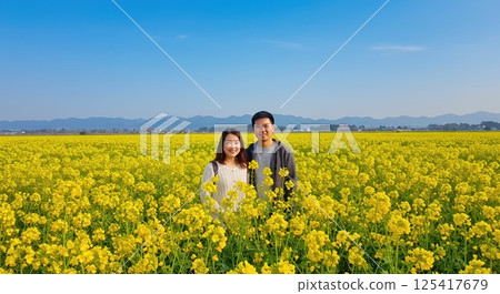 People hiking in a rapeseed field 125417679