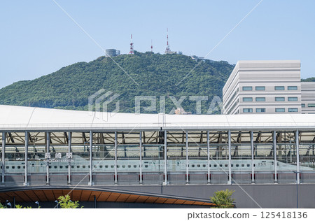 Nagasaki City, Nagasaki Prefecture: The rebuilt JR Nagasaki Station (with a parked Shinkansen train and Mount Inasa visible in the background) 125418136