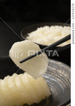 Bettara pickles and rice on a black background Bettara pickles and rice on a black background 125418178