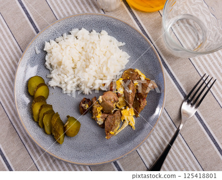 Top view gray ceramic plate of flavored omelet with rabbit liver with rice and pickles 125418801
