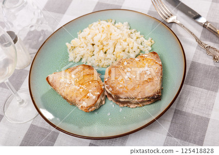 Two pieces of juicy grilled tuna steaks served with rice 125418828