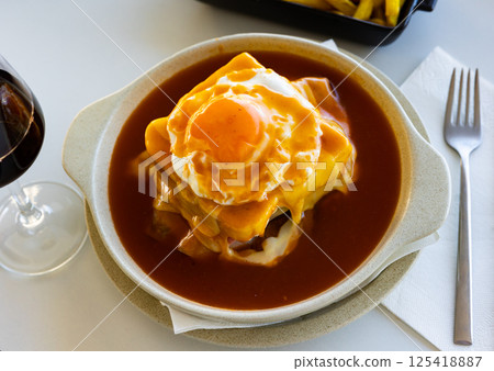Traditional Portuguese sandwich, francesinha, served on table Traditional Portuguese sandwich, francesinha, served on table 125418887