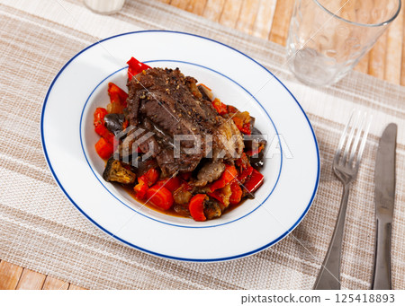 Baked pork chop with sauteed bell pepper, tomatoes, eggplant Baked pork chop with sauteed bell pepper, tomatoes, eggplant 125418893
