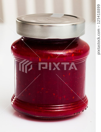 Raspberry jam in closed glass jar Raspberry jam in closed glass jar 125418899