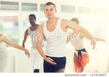 Concentrated women and men rehearsing ballet dance in class Concentrated women and men rehearsing ballet dance in class 125419007