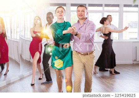 Man and woman dancing waltz in couple during lesson at studio Man and woman dancing waltz in couple during lesson at studio 125419025