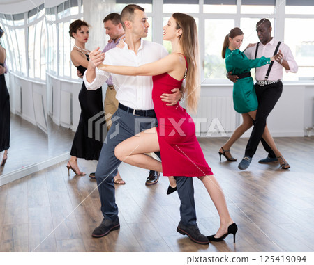 Young man and woman practicing waltz in dancing studio 125419094