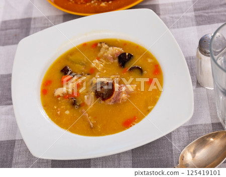 Nice plate of hot pea soup with smoked meat ready to eat 125419101