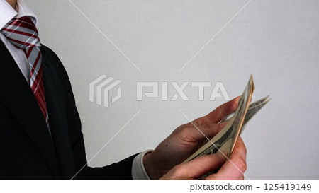 Businessman counting banknotes Businessman counting banknotes 125419149