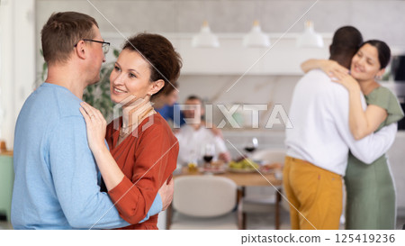 Woman enjoying slow dance with man at house party Woman enjoying slow dance with man at house party 125419236
