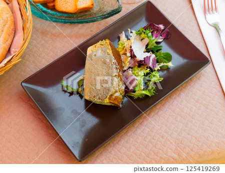 Delicious pie prepared with leek and served with salad Delicious pie prepared with leek and served with salad 125419269
