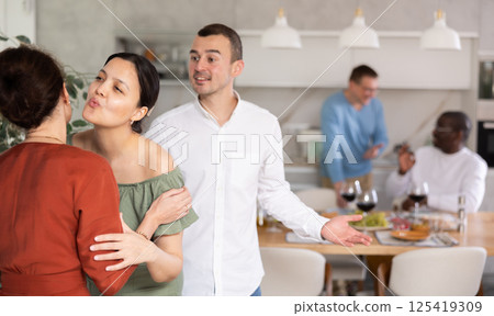 Two women greet each other when meeting Two women greet each other when meeting 125419309