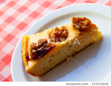 Cake with walnuts on white plate 125419348