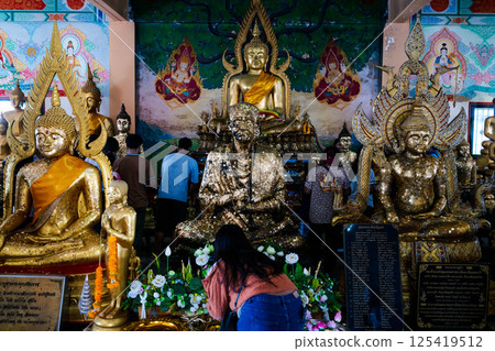 March 16, 2025, Wat Hong Thong in Chachoengsao, Visitors admire golden Buddha statues in Thailand as they engage in cultural and spiritual activities March 16, 2025, Wat Hong Thong in Chachoengsao, Visitors admire golden Buddha statues in Thailand as they engage in cultural and spiritual activities 125419512
