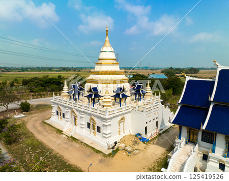 Lopburi, Thailand, April 07, 2024, Discover Wat Phra Nang Chamathewi, Showcasing intricate architecture under a clear blue sky in April 125419526