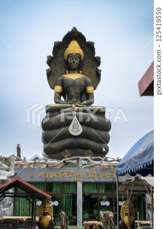 Lopburi, Thailand, April 14, 2025, Giant Buddha statue at Wat Tamtako, captivating visitors 125419550