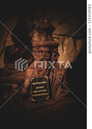 Lopburi, Thailand, April 14, 2025, Exploring Wat Tamtako, featuring sacred statues and religious artifacts at dusk in April 125419563