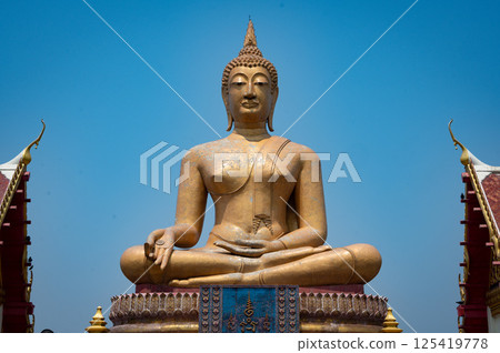 Singburi, Thailand, March 23, 2025, Buddha statue at Wat Phikun Thong showcases serenity and spirituality in a bright sky 125419778