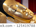 Singburi, Thailand, March 23, 2025, Golden reclining Buddha statue at Wat Phra Non Chak Si Worawihan 125419788