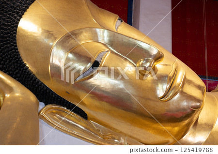 Singburi, Thailand, March 23, 2025, Golden reclining Buddha statue at Wat Phra Non Chak Si Worawihan Singburi, Thailand, March 23, 2025, Golden reclining Buddha statue at Wat Phra Non Chak Si Worawihan 125419788
