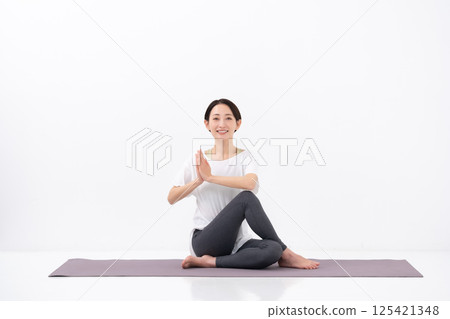 Woman doing yoga, middle-aged Woman doing yoga, middle-aged 125421348