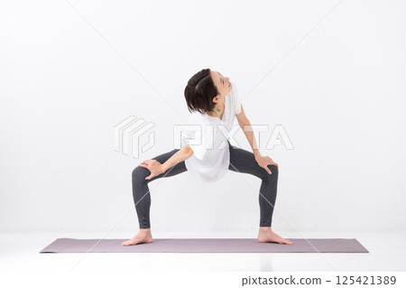 Woman doing yoga, middle-aged Woman doing yoga, middle-aged 125421389