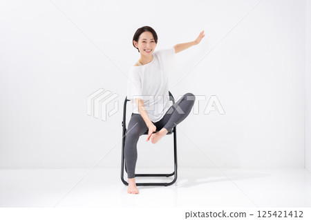 Woman doing chair yoga, middle-aged 125421412