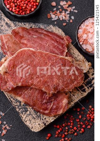 Jerky, dried pork meat slices with salt and spices 125421545
