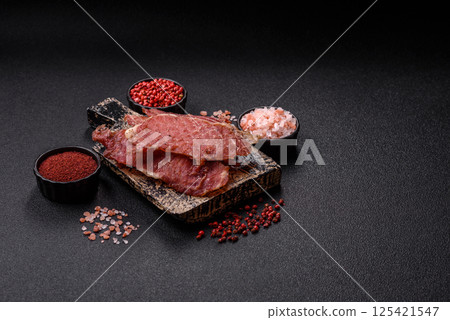 Jerky, dried pork meat slices with salt and spices 125421547