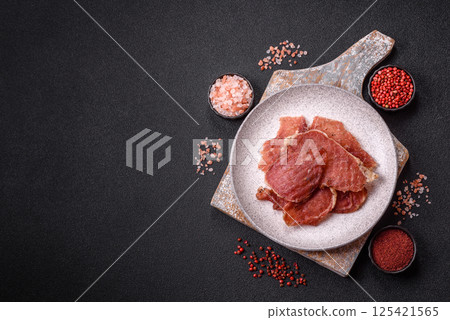 Jerky, dried pork meat slices with salt and spices 125421565