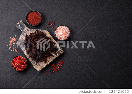 Jerky, dried horse meat or beef slices with salt and spices 125421623