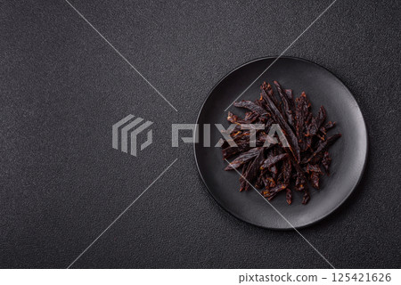 Jerky, dried horse meat or beef slices with salt and spices 125421626