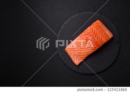 Fresh raw salmon steak with spices and herbs Fresh raw salmon steak with spices and herbs 125421868