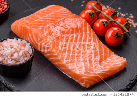 Fresh raw salmon steak with spices and herbs Fresh raw salmon steak with spices and herbs 125421874