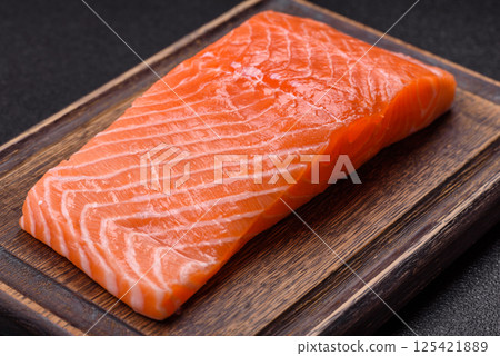 Fresh raw salmon steak with spices and herbs Fresh raw salmon steak with spices and herbs 125421889