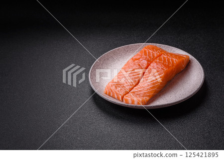 Fresh raw salmon steak with spices and herbs Fresh raw salmon steak with spices and herbs 125421895