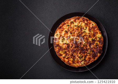Delicious fresh quiche with broccoli, cheese, spices and herbs 125421910