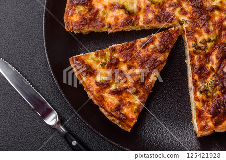 Delicious fresh quiche with broccoli, cheese, spices and herbs 125421928