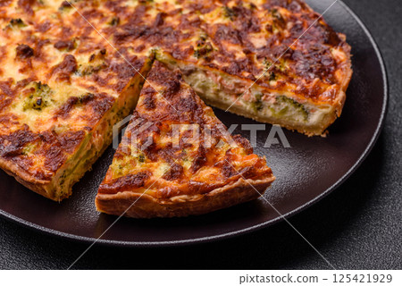 Delicious fresh quiche with broccoli, cheese, spices and herbs Delicious fresh quiche with broccoli, cheese, spices and herbs 125421929
