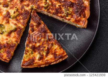 Delicious fresh quiche with broccoli, cheese, spices and herbs Delicious fresh quiche with broccoli, cheese, spices and herbs 125421930