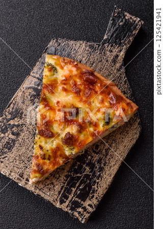 Delicious fresh quiche with broccoli, cheese, spices and herbs 125421941