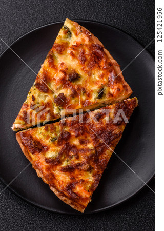 Delicious fresh quiche with broccoli, cheese, spices and herbs Delicious fresh quiche with broccoli, cheese, spices and herbs 125421956