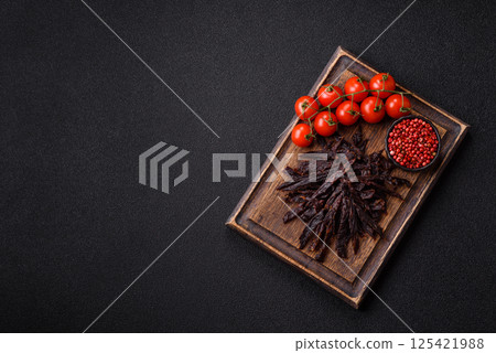 Jerky, dried horse meat or beef slices with salt and spices 125421988