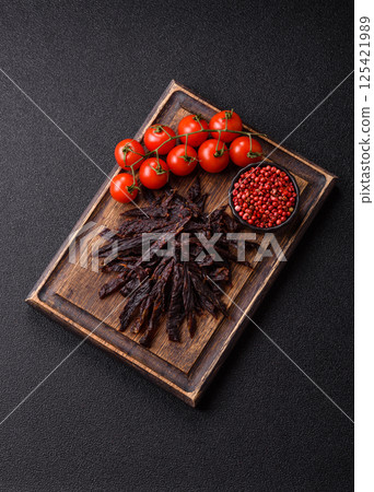 Jerky, dried horse meat or beef slices with salt and spices 125421989