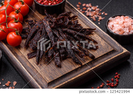 Jerky, dried horse meat or beef slices with salt and spices 125421994