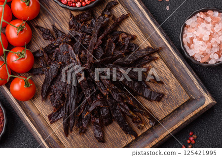 Jerky, dried horse meat or beef slices with salt and spices 125421995