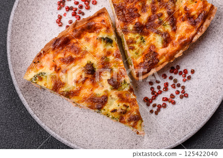 Delicious fresh quiche with broccoli, cheese, spices and herbs 125422040